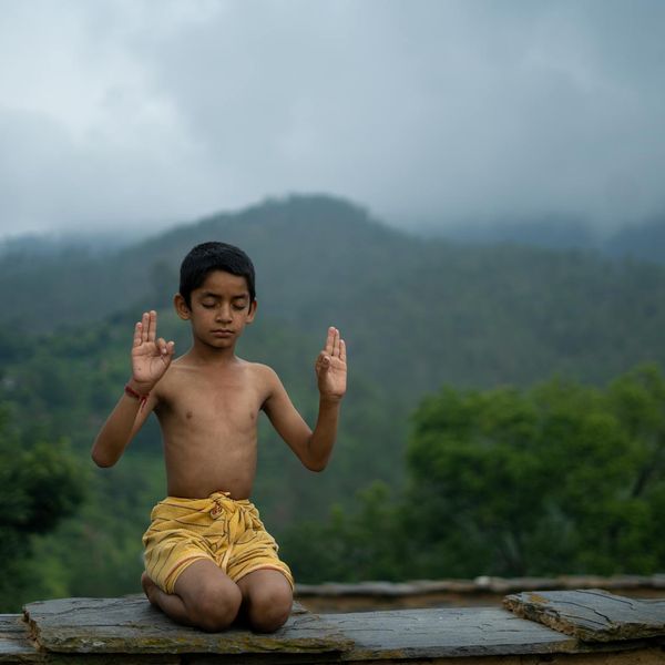 Person performing an energetic yoga pose against a beautiful natural background.